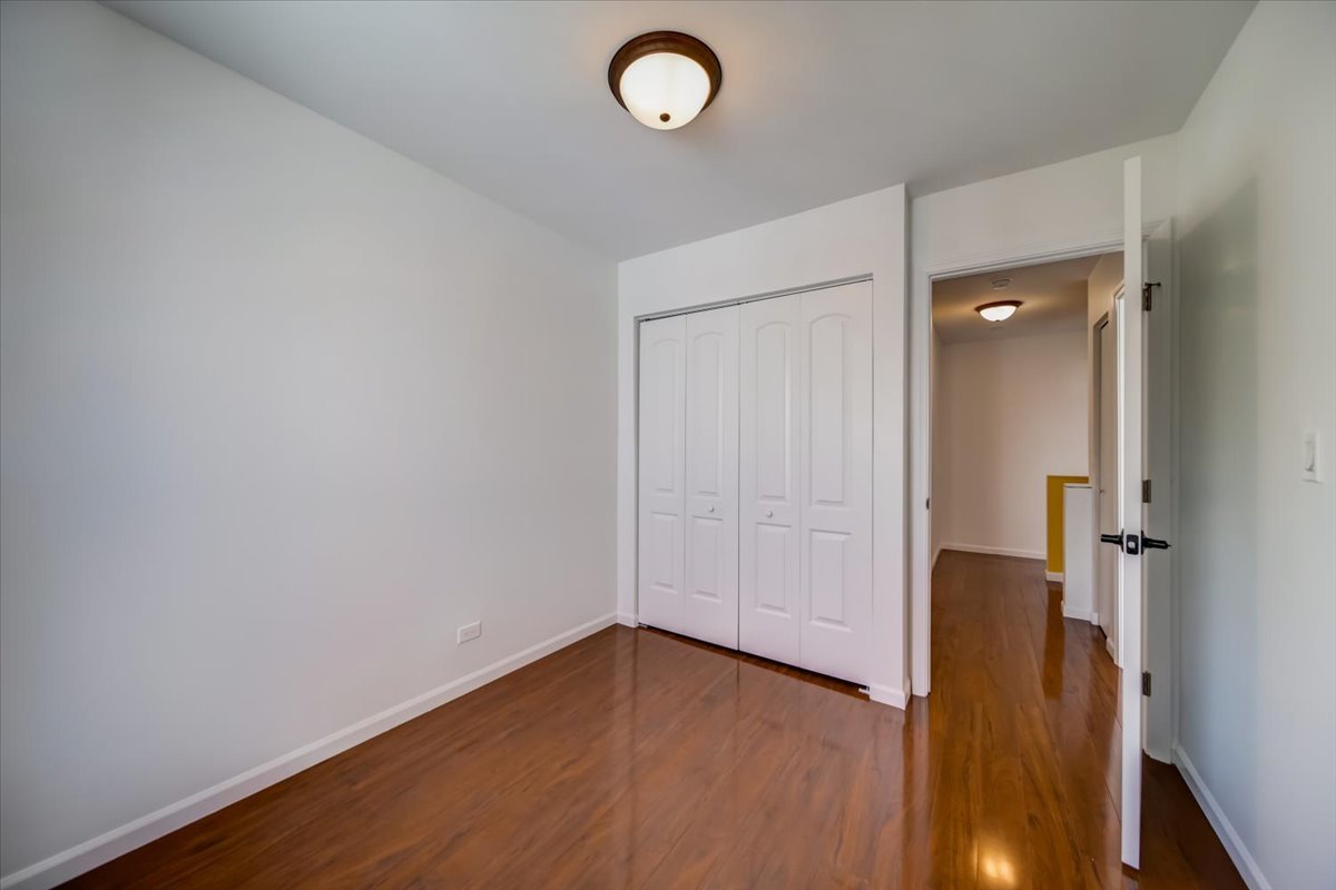 2414 West Harrison Street, Unit E Chicago, IL 60612 - Photo 23 of 37 wooden floor in an empty room
