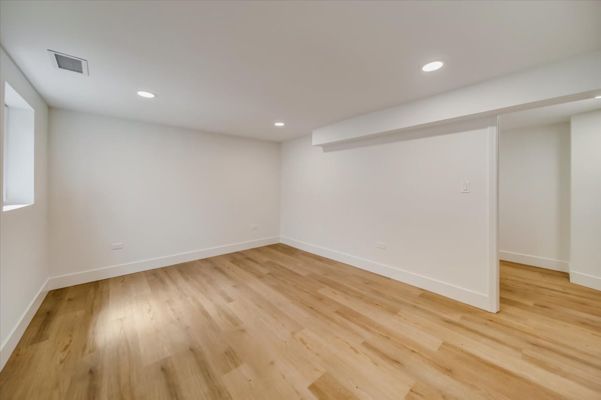 2414 West Harrison Street, Unit E Chicago, IL 60612 - Photo 31 of 37 a view of empty room with wooden floor