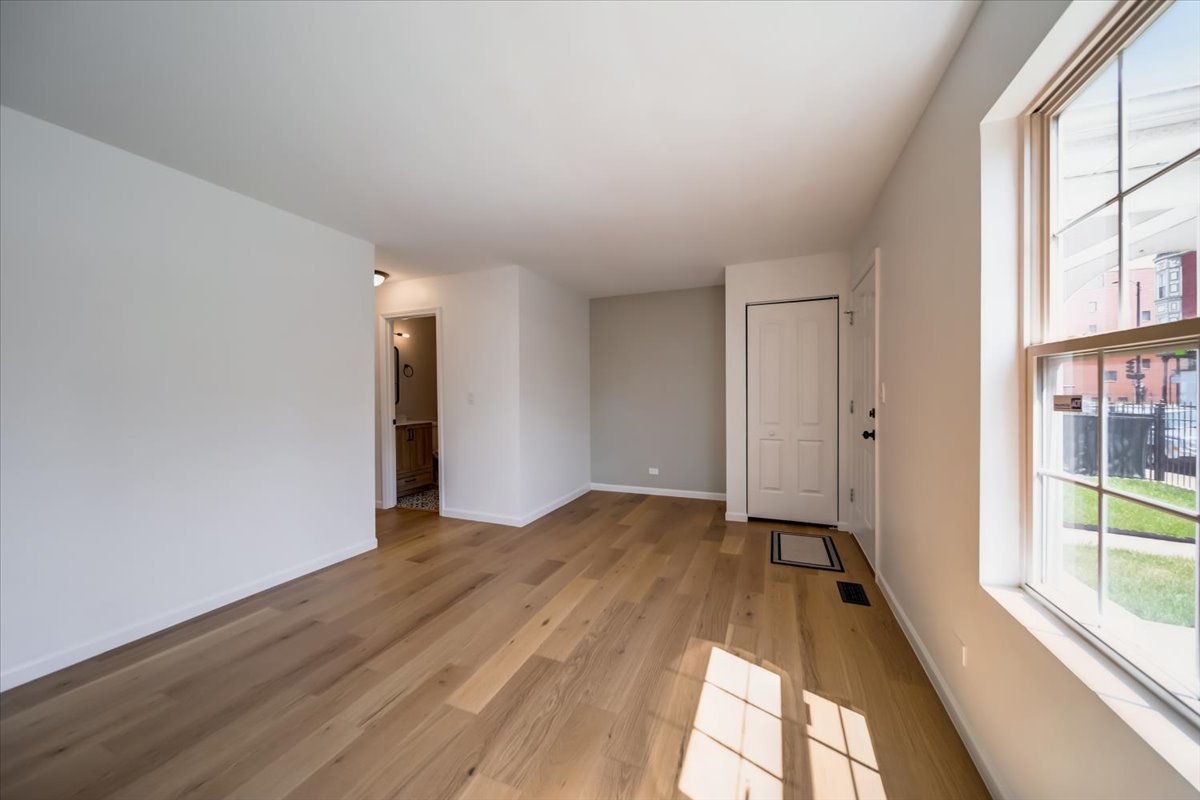 2414 West Harrison Street, Unit E Chicago, IL 60612 - Photo 4 of 37 a view of an empty room and window