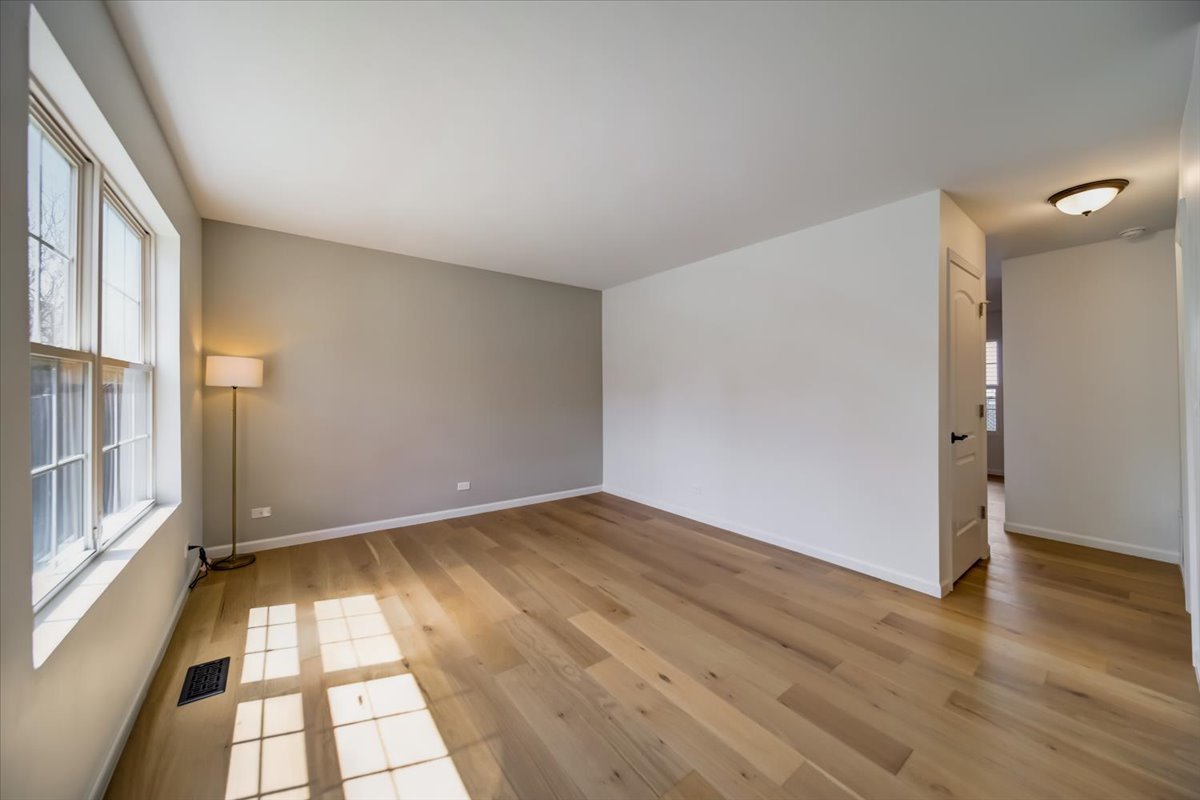 2414 West Harrison Street, Unit E Chicago, IL 60612 - Photo 5 of 37 wooden floor in an empty room with a window