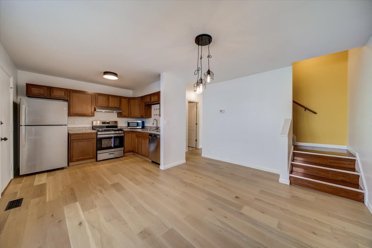2414 West Harrison Street, Unit E Chicago, IL 60612 - Photo 9 of 37 a kitchen with stainless steel appliances a refrigerator and a stove top oven