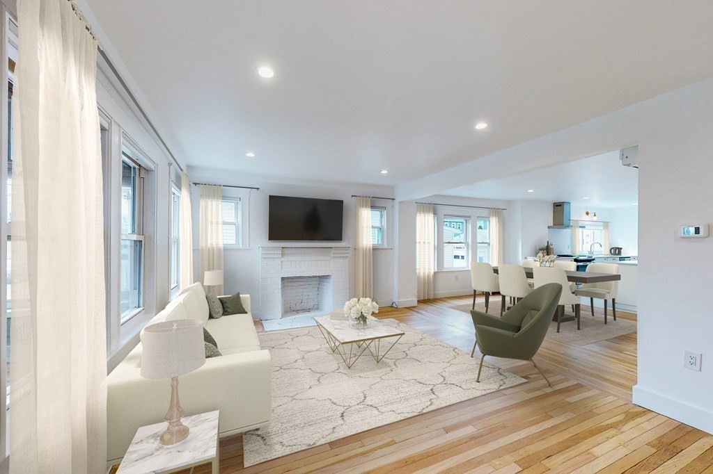 a living room with fireplace furniture and a flat screen tv