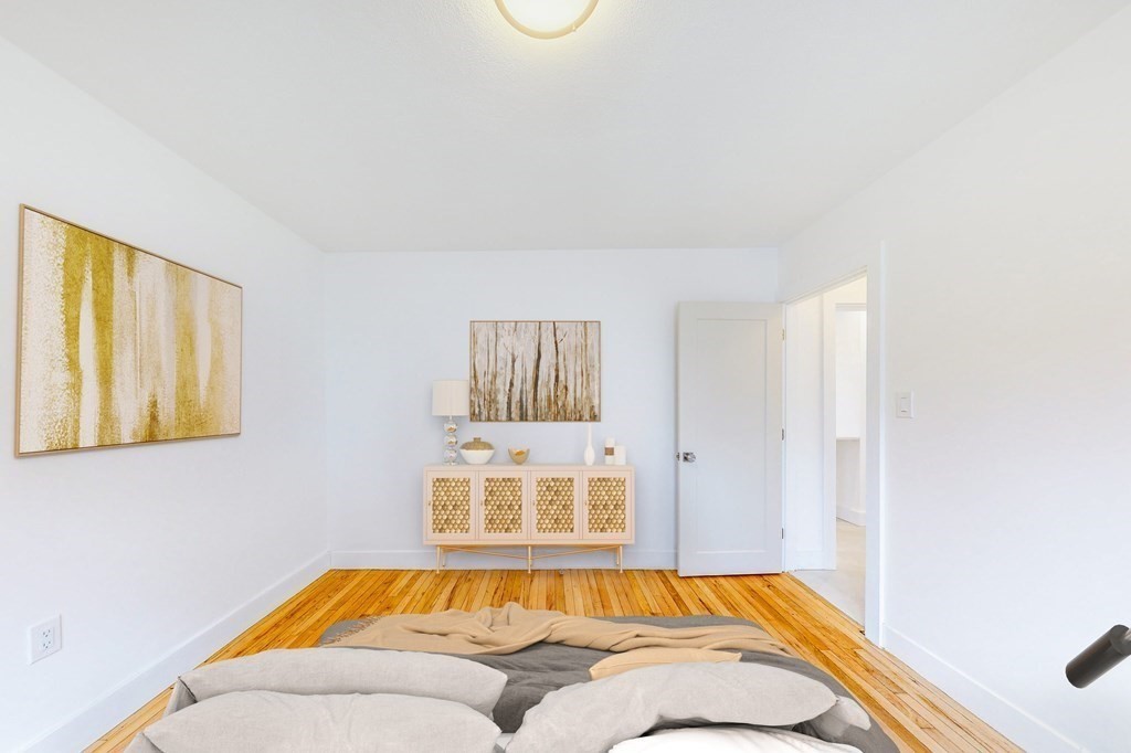 14 Olney Street, Unit 1 Watertown, MA 02472 - Photo 6 of 13 a bedroom with a bed and a window