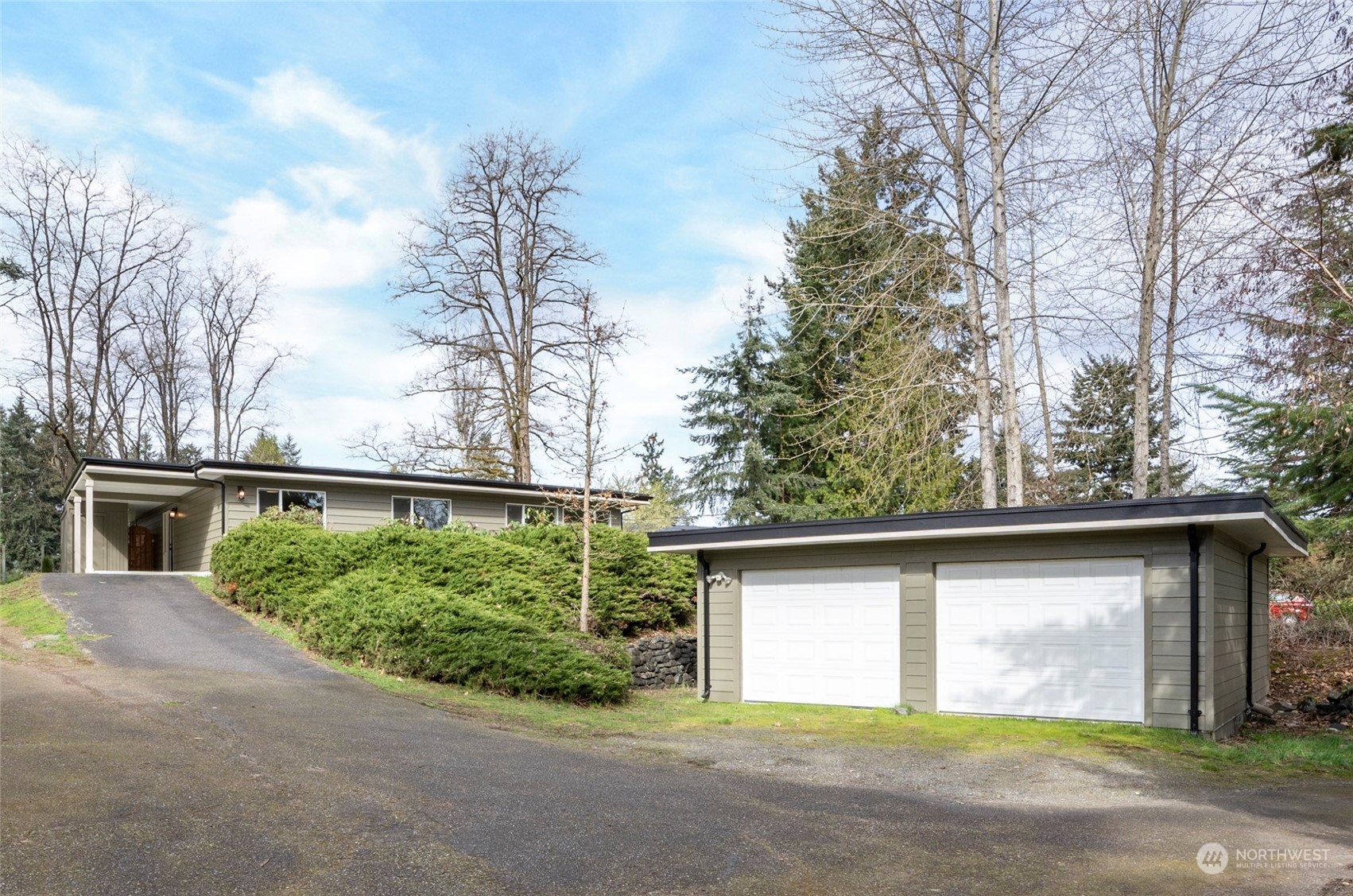 11012 Military Road Southwest Lakewood, WA 98498 - Photo 1 of 34 a front view of a house with a yard and garage