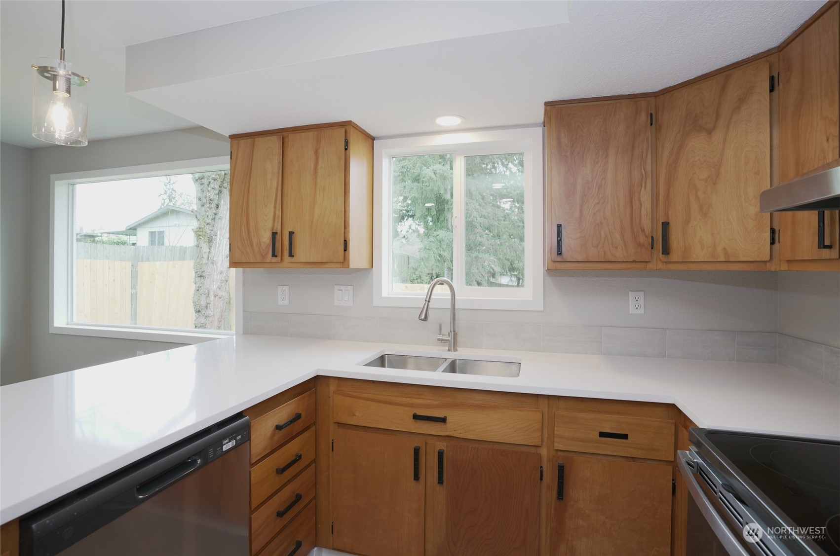 11012 Military Road Southwest Lakewood, WA 98498 - Photo 13 of 34 a kitchen with a sink cabinets and window