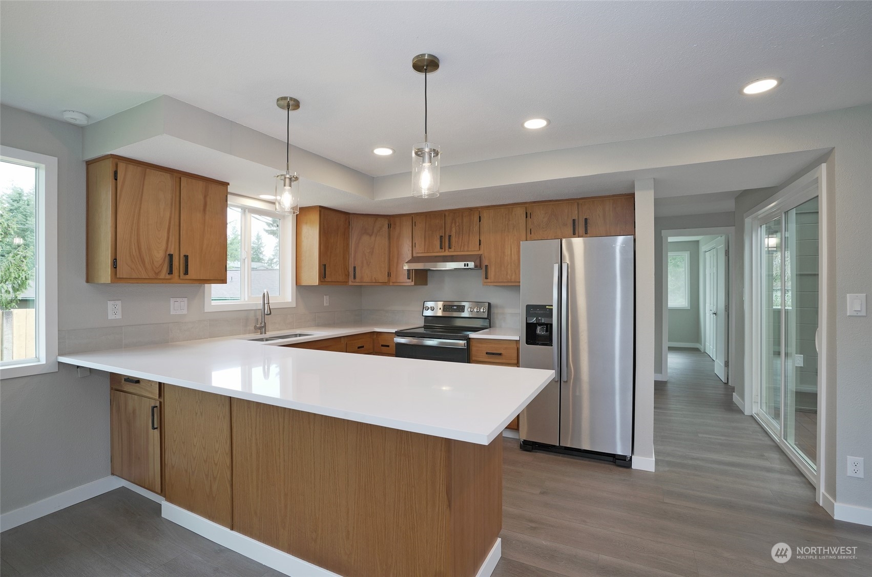 11012 Military Road Southwest Lakewood, WA 98498 - Photo 15 of 34 a kitchen with refrigerator cabinets and wooden floor