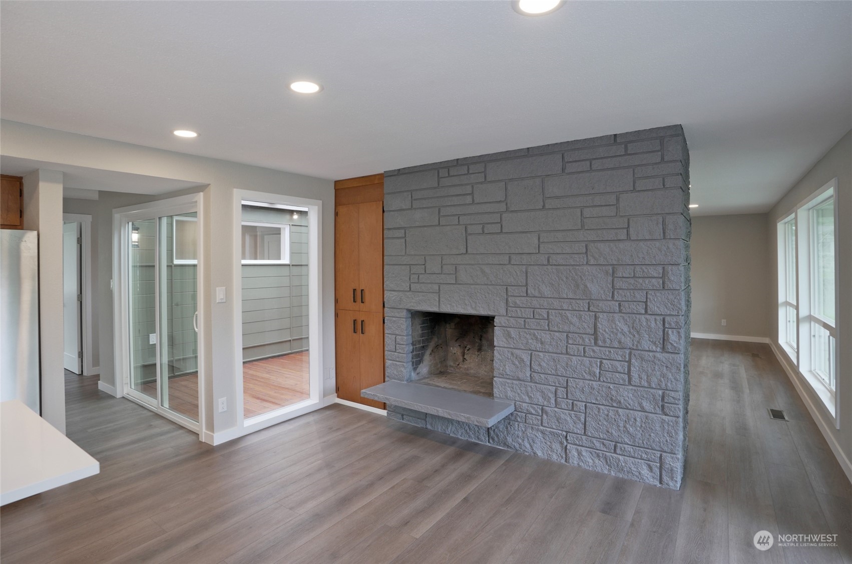 11012 Military Road Southwest Lakewood, WA 98498 - Photo 17 of 34 an empty room with wooden floor fireplace and windows