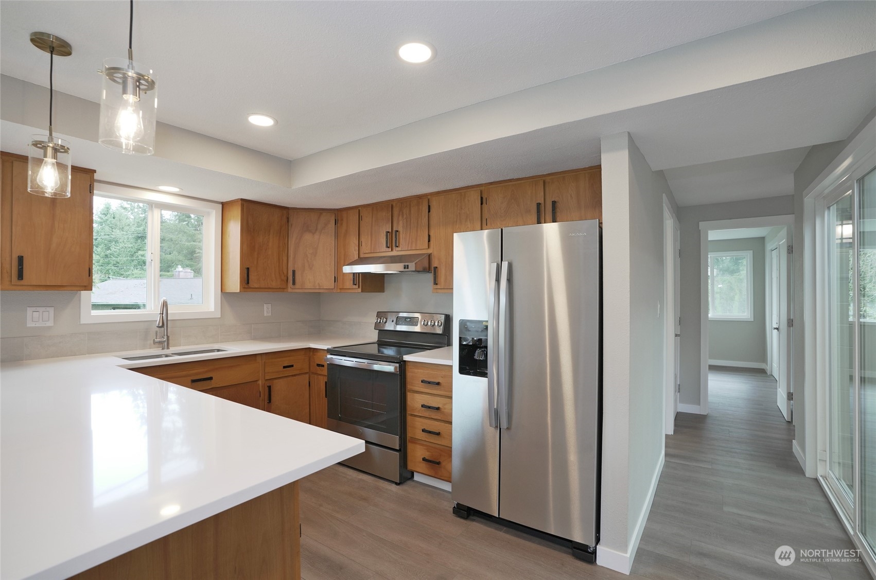 11012 Military Road Southwest Lakewood, WA 98498 - Photo 18 of 34 a kitchen with granite countertop a refrigerator stove and sink
