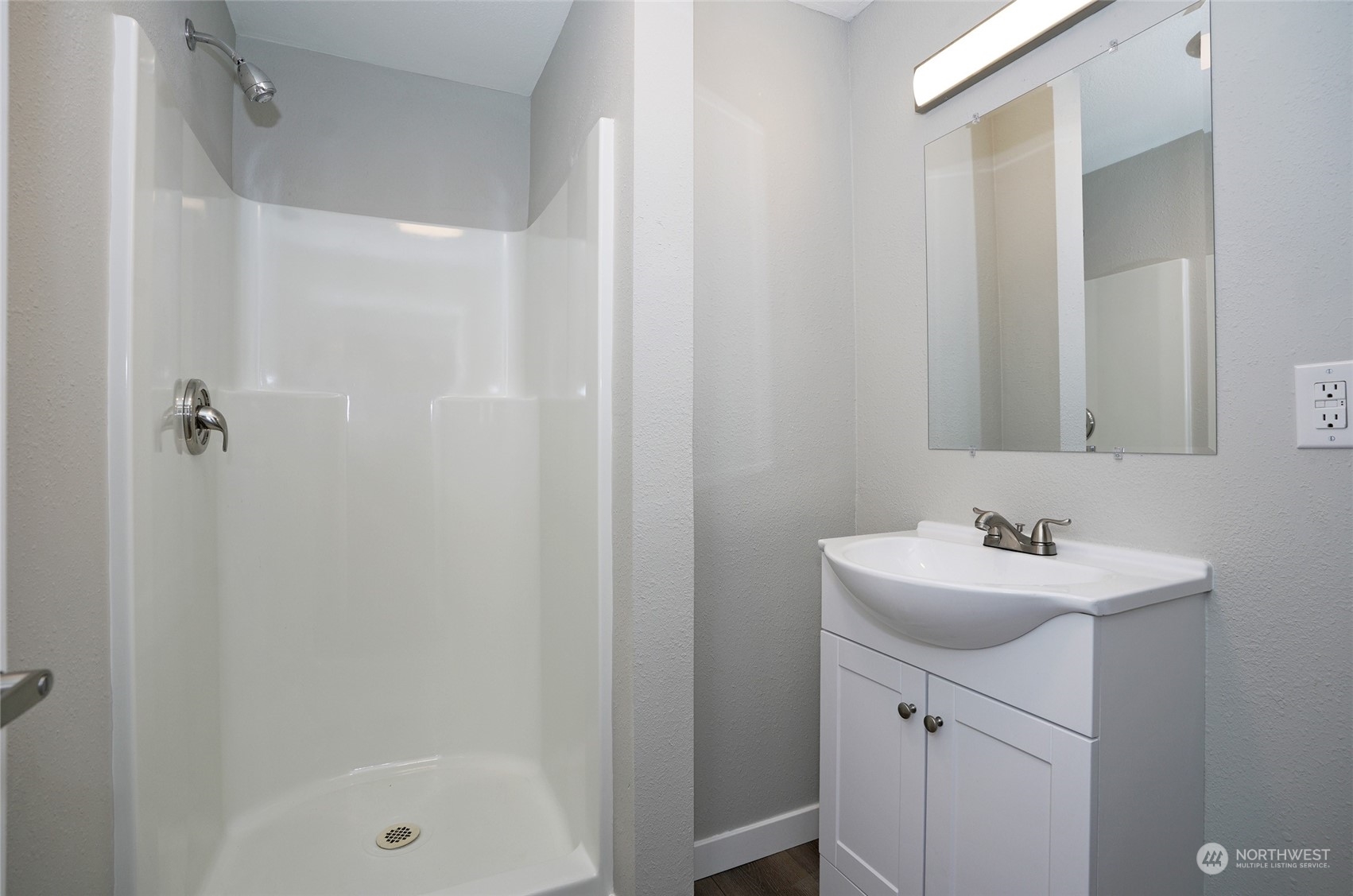 11012 Military Road Southwest Lakewood, WA 98498 - Photo 27 of 34 a bathroom with a sink a mirror and a bathtub