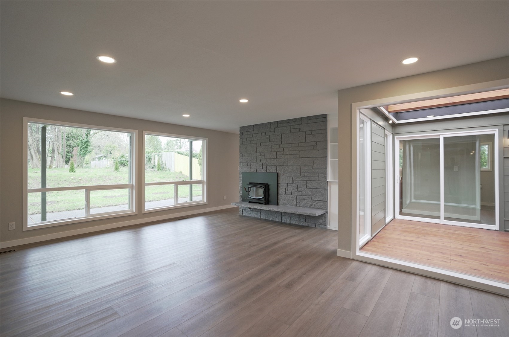 11012 Military Road Southwest Lakewood, WA 98498 - Photo 6 of 34 a view of an empty room with wooden floor and a window