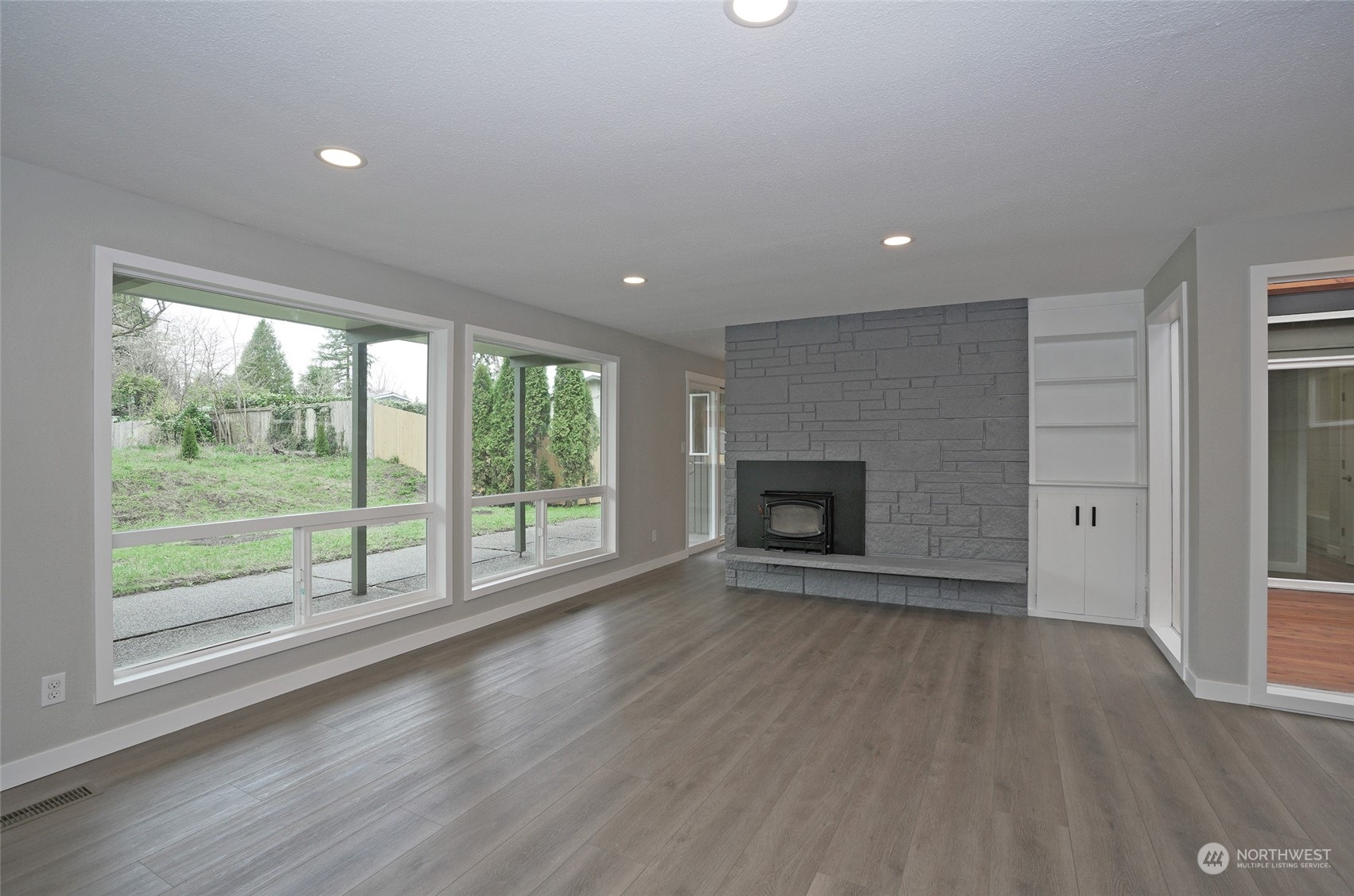 11012 Military Road Southwest Lakewood, WA 98498 - Photo 10 of 34 an empty room with wooden floor and windows