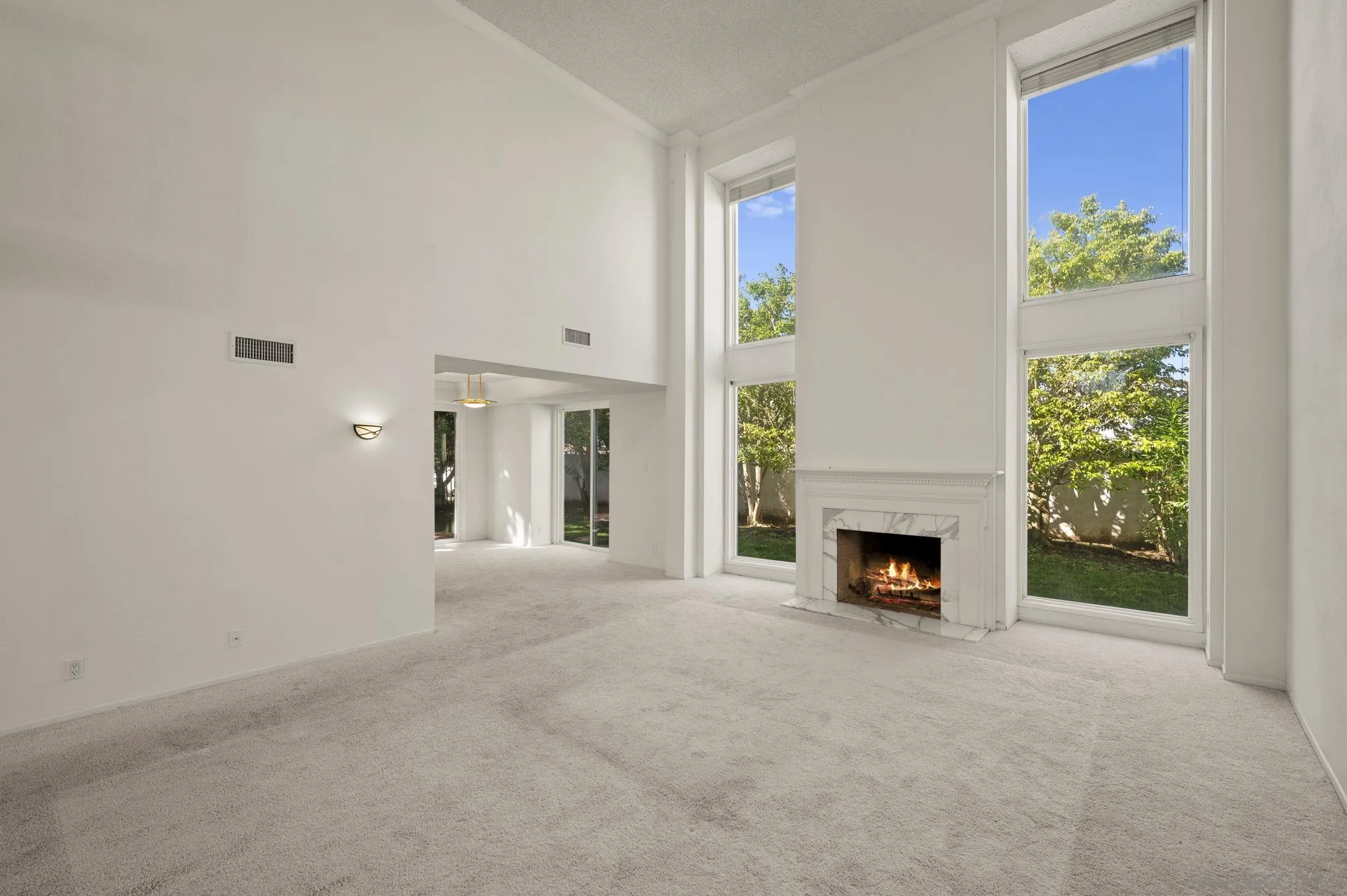 2847 Via Posada La Jolla, CA 92037 - Photo 7 of 21 a view of an empty room with a fireplace and a window