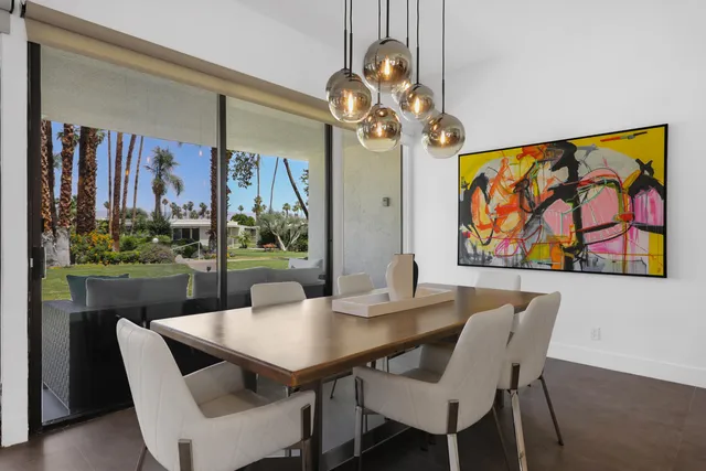 a view of a dining room with furniture a chandelier and wooden floor