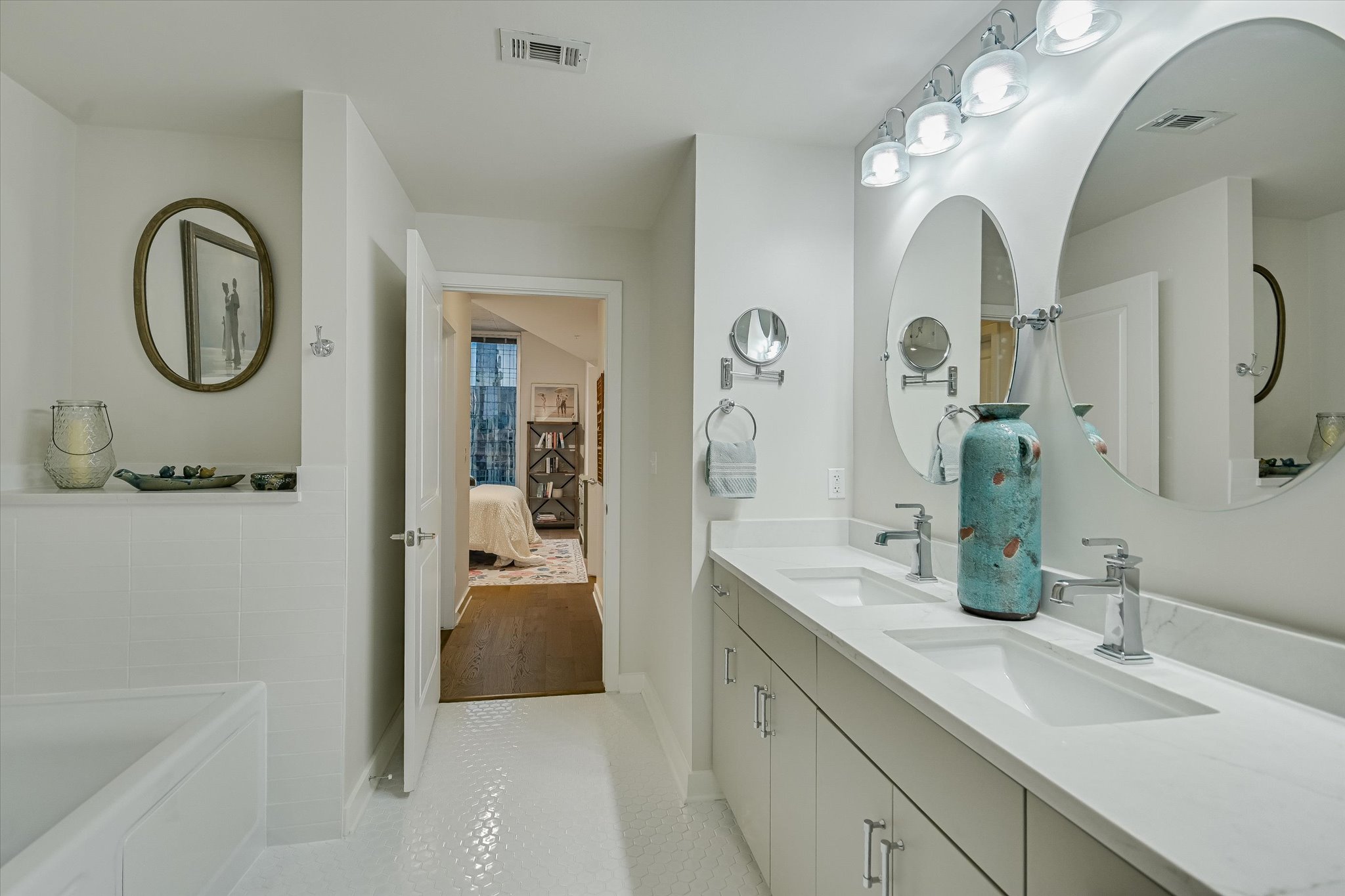 360 Nueces Street, Unit 1405 Austin, TX 78701 - Photo 17 of 40 a en suite bathroom with a double vanity sink and a mirror