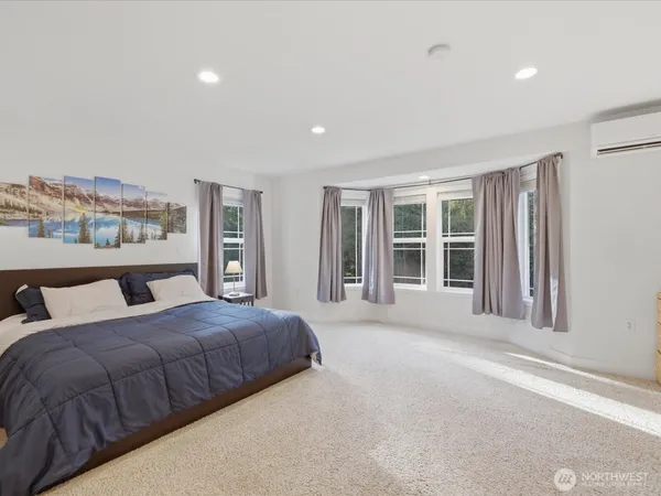 a bedroom with a large bed and a large window