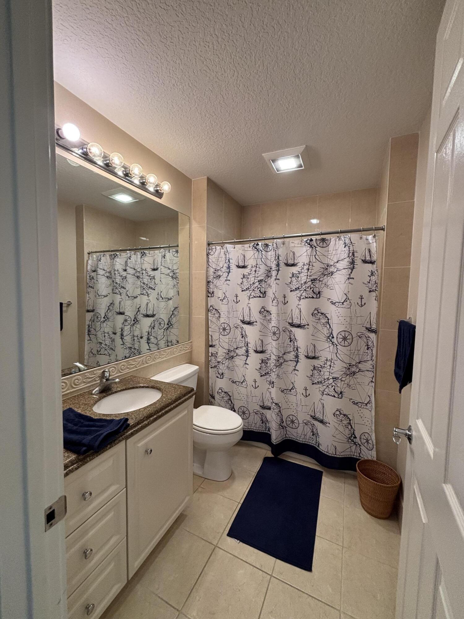 14 Harbour Isle Drive West, Unit 202 Fort Pierce, FL 34949 - Photo 16 of 18 a bathroom with a double vanity sink toilet and shower