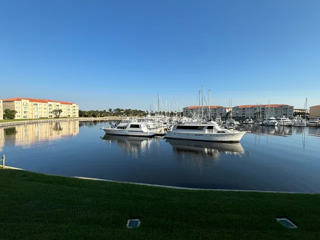a view of a lake with boats and trees in the background
