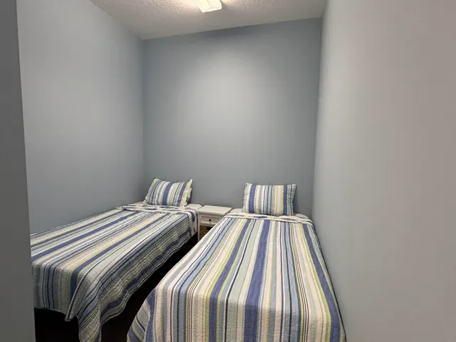 a bed sitting in a bedroom next to a window