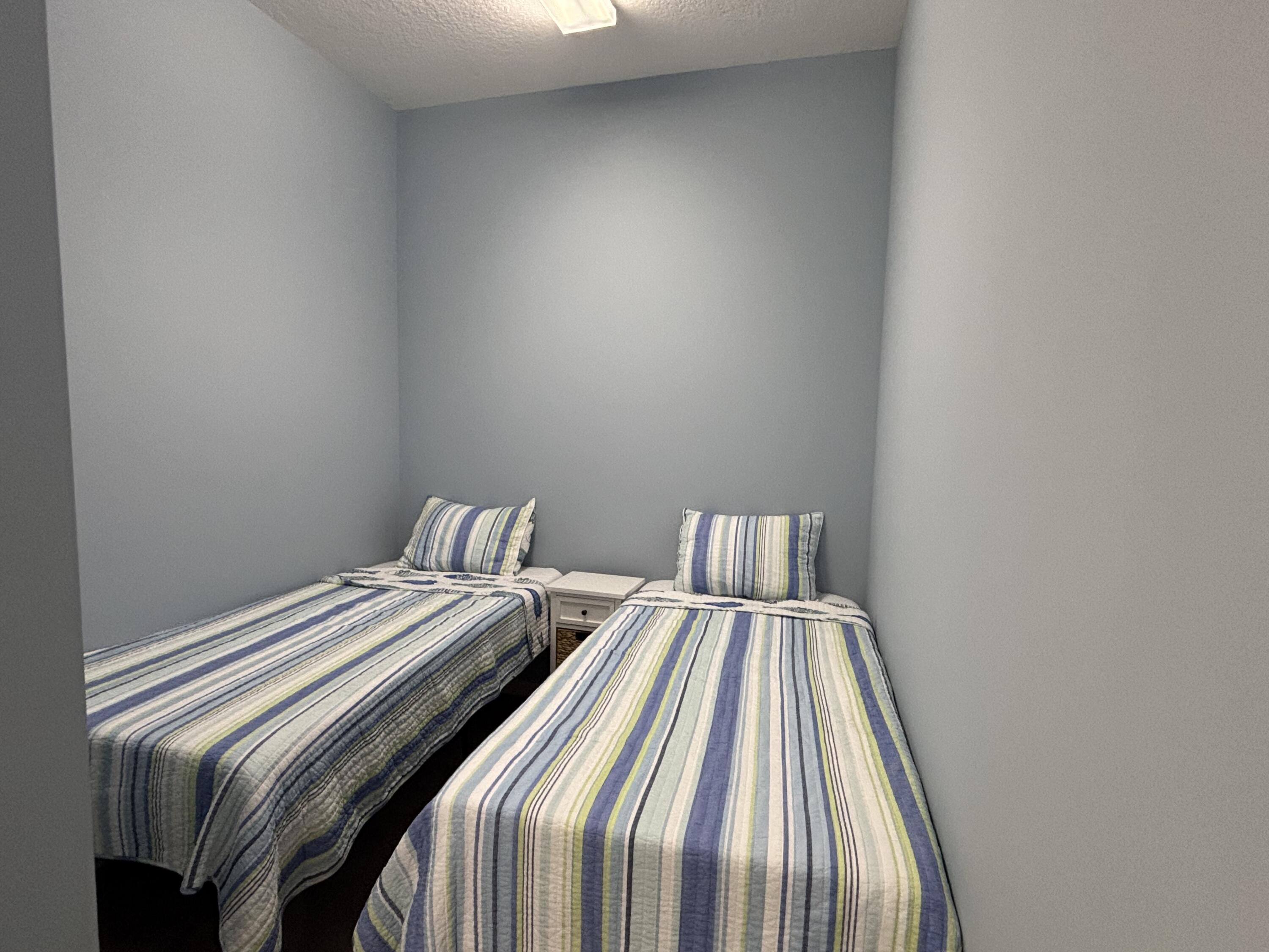 14 Harbour Isle Drive West, Unit 202 Fort Pierce, FL 34949 - Photo 18 of 18 a bed sitting in a bedroom next to a window