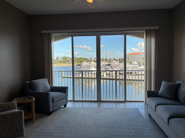 a living room with furniture and a floor to ceiling window