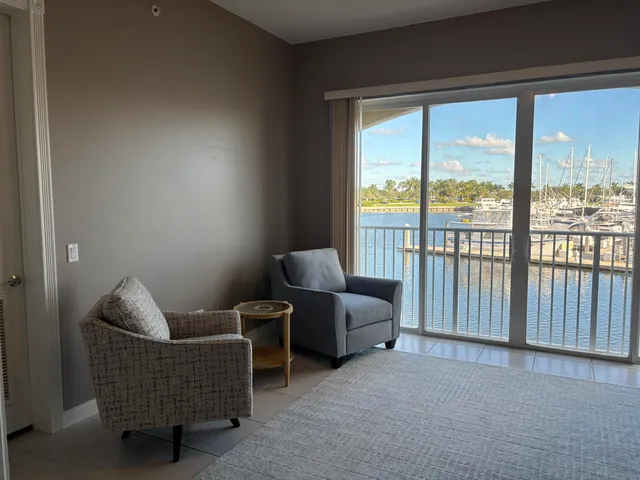 a living room with furniture and a floor to ceiling window