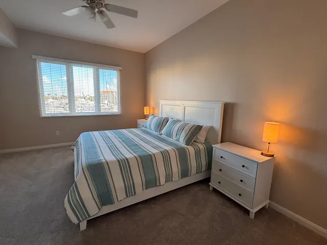 a spacious bedroom with a bed and a chandelier