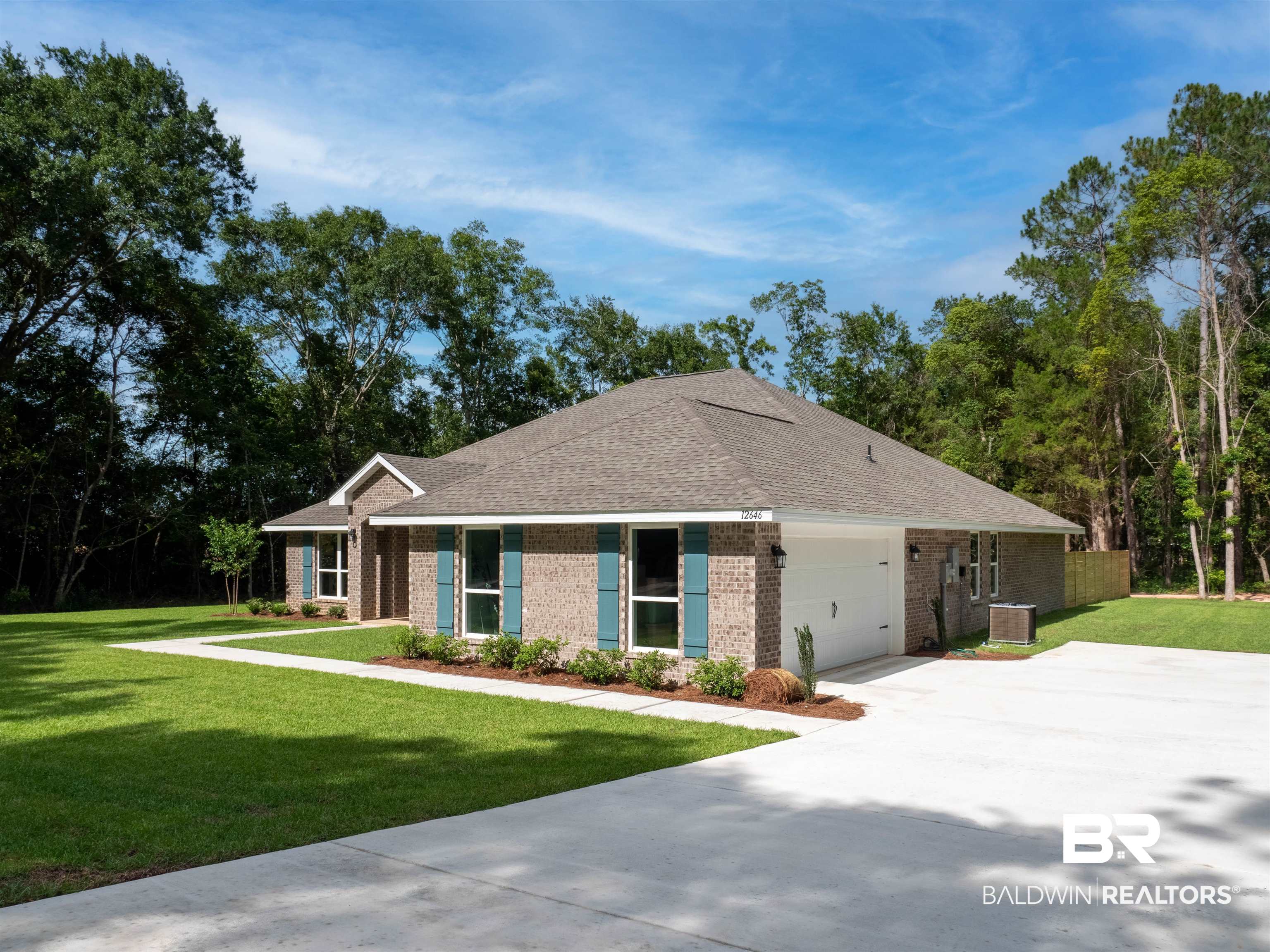 12646 Michigan Avenue Elberta, AL 36530 - Photo 2 of 47 View of front of property featuring a front yard, brick siding, concrete driveway, an attached garage, and roof with shingles