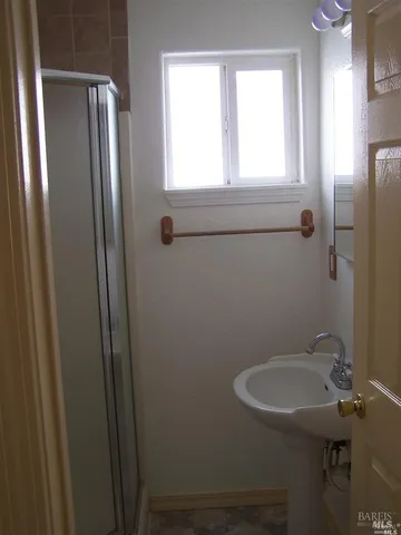 a bathroom with a sink a toilet and a mirror