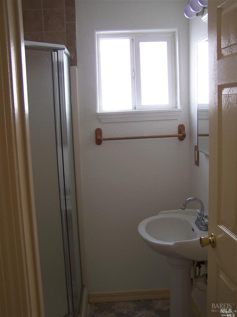 148 North 3rd Street Rio Vista, CA 94571 - Photo 11 of 11 a bathroom with a sink a toilet and a mirror