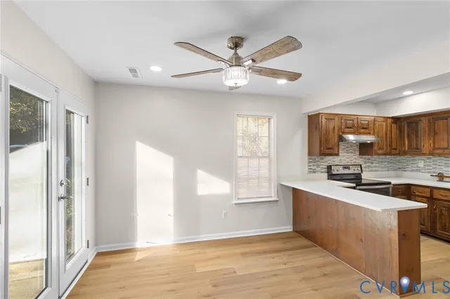 a view of a kitchen with a sink wooden floor and a window