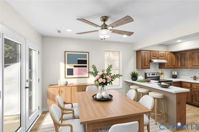 a kitchen with a table and chairs in it