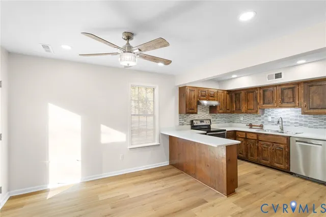 a kitchen with stainless steel appliances granite countertop a sink and stove