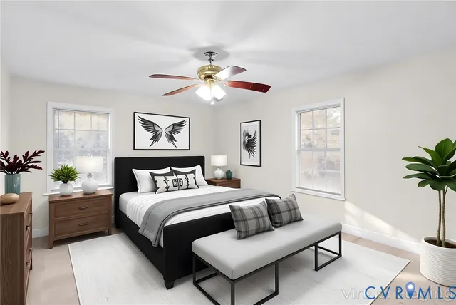 a bedroom with a bed couches and a potted plant