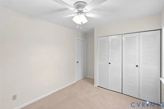 a view of a livingroom with a chandelier fan