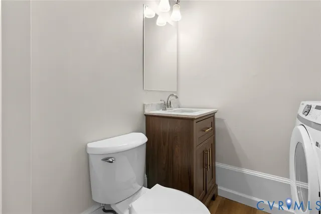 a bathroom with a toilet a sink and mirror