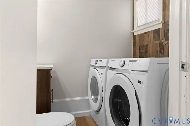 a view of bathroom with washing machine and toilet