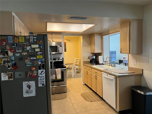 a kitchen with refrigerator and cabinets