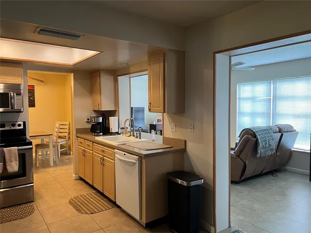 a kitchen with a stove a sink and a refrigerator