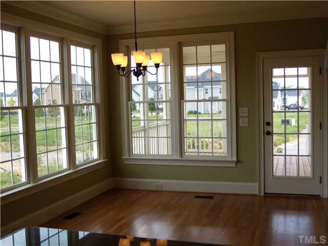 1210 Ileagnes Road Raleigh, NC 27603 - Photo 4 of 7 a view of an empty room with wooden floor and a window