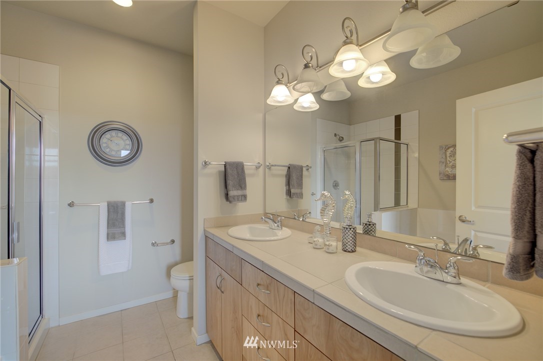 114 Cougar Ridge Road Northwest, Unit 1701 Issaquah, WA 98027 - Photo 12 of 25 a bathroom with a double vanity sink and a mirror