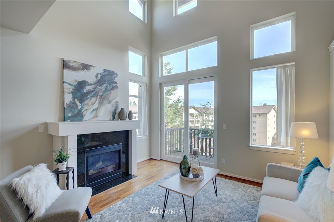114 Cougar Ridge Road Northwest, Unit 1701 Issaquah, WA 98027 - Photo 5 of 25 a living room with furniture a window and a fireplace