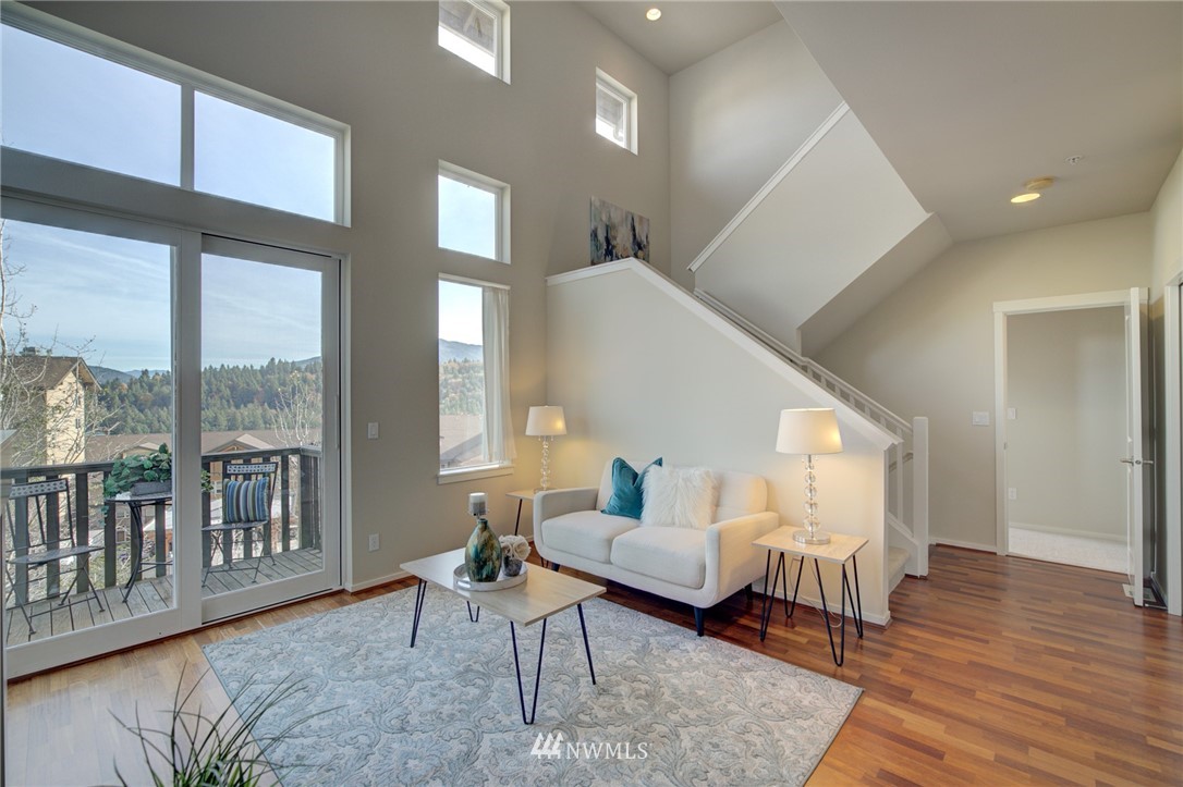 114 Cougar Ridge Road Northwest, Unit 1701 Issaquah, WA 98027 - Photo 6 of 25 a living room with furniture and a wooden floor