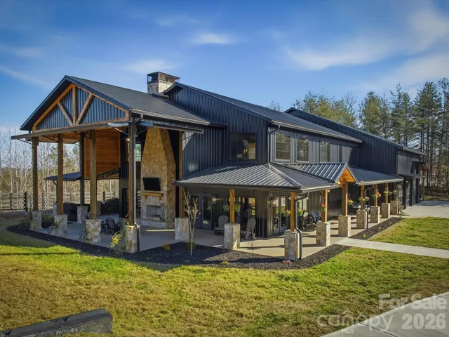 a patio with a table and chairs under an umbrella