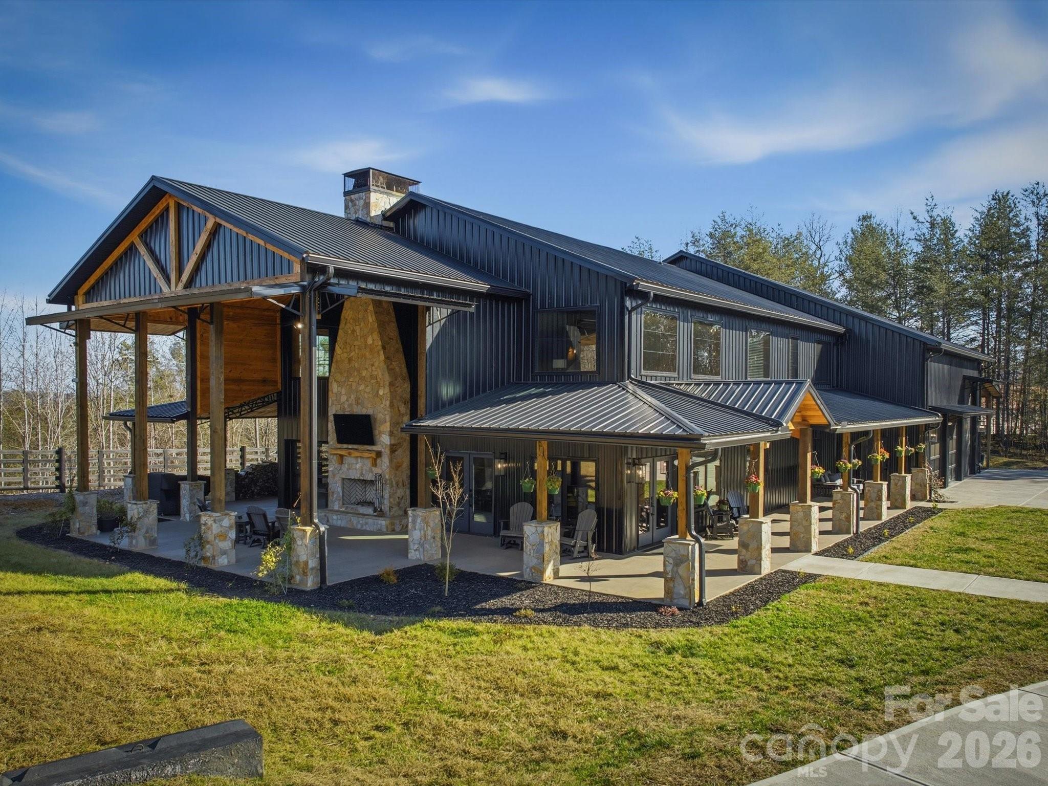 a patio with a table and chairs under an umbrella
