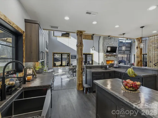 a kitchen with stainless steel appliances kitchen island granite countertop a stove and a sink