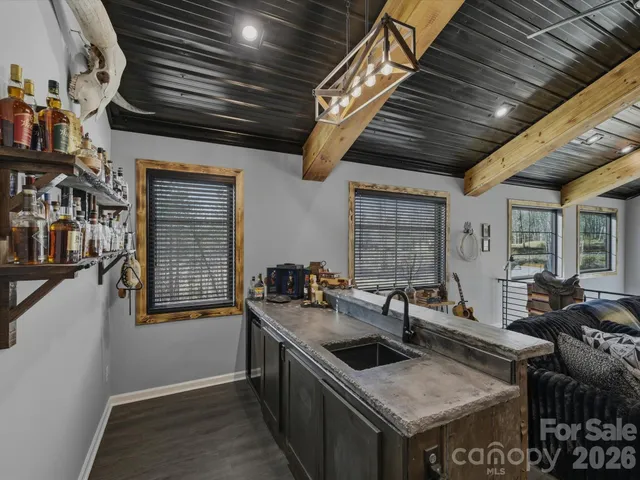 a bedroom with a bed and a large window with balcony view