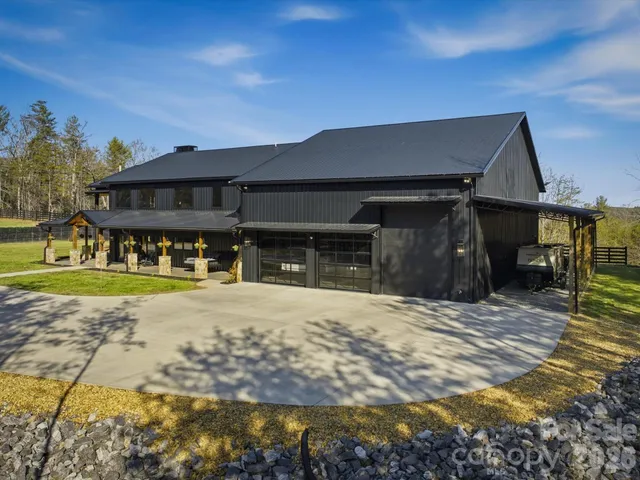 a view of a house with swimming pool and sitting area