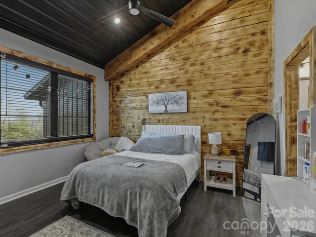 a en suite bathroom with a granite countertop sink vanity and a mirror