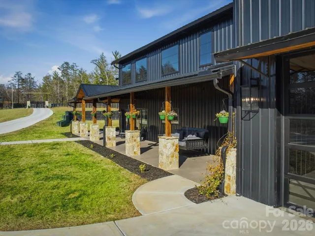 a view of a house with backyard porch and sitting area