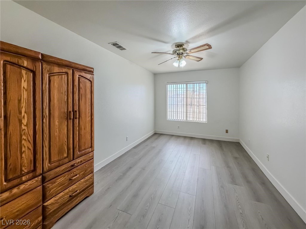 5308 Scoreboard Street Las Vegas, NV 89130 - Photo 12 of 32 Unfurnished bedroom with a ceiling fan and light wood finished floors